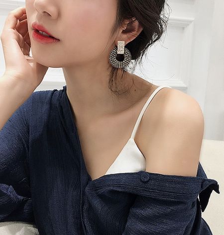 Model wearing the black and clear crystal statement earrings to showcase scale and style.