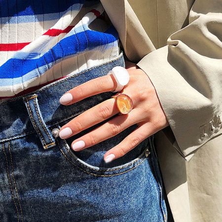 A model wearing the glass dome ring, showcasing its style in a fashion context.
