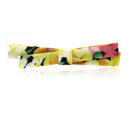 Yellow Flower Fabric Print Hair Pin - A close-up of the Yellow Flower Fabric Print Hair Pin, showing its detailed floral pattern and bow-knot shape.
