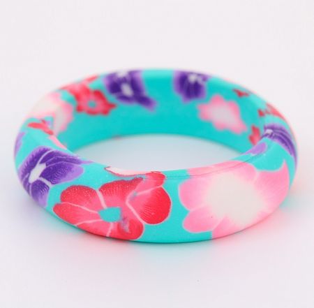 Close-up of a teal bracelet with a vibrant floral pattern, showcasing the detailed resin/acrylic material.