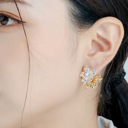 Woman modeling the elegant flower-shaped stud earring, demonstrating its stylish appeal.