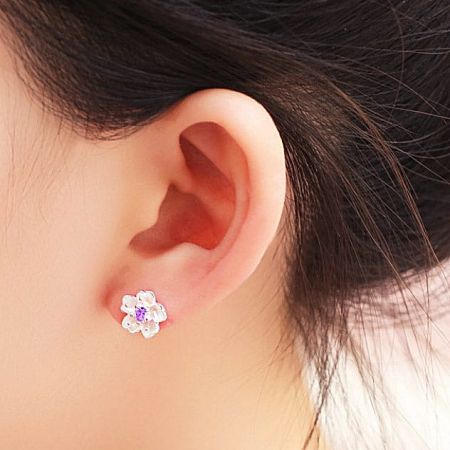 Model wearing the cherry blossom stud earring to show scale and style.