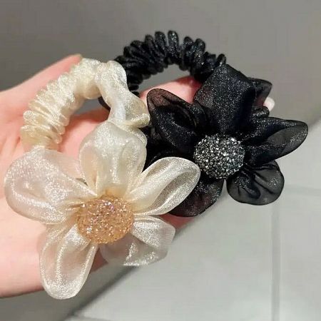 Close-up of the white and black organza flower hair ties.