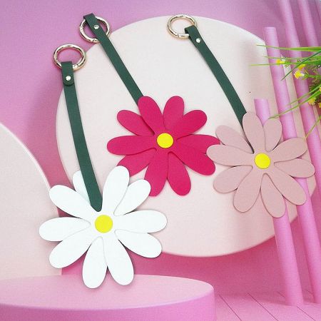 Girls Carabiner Hook PU Leather Flower Bag Charms (Set of 5) - A collection of PU leather daisy flower bag charms in white, pink, and light brown, each with a green strap and gold carabiner hook.