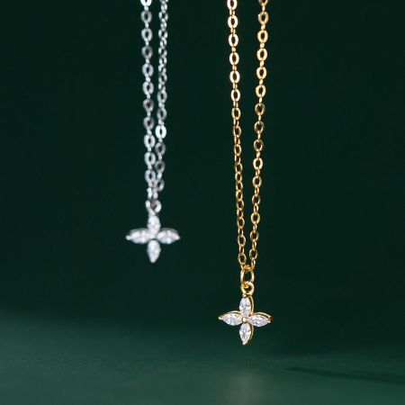 925 Sterling Silver Tiny Four Leaf Clover Flower Necklace Set - A pair of 925 sterling silver four-leaf clover flower necklaces, one in a polished silver finish and the other in a radiant gold finish, both featuring delicate gemstone details.