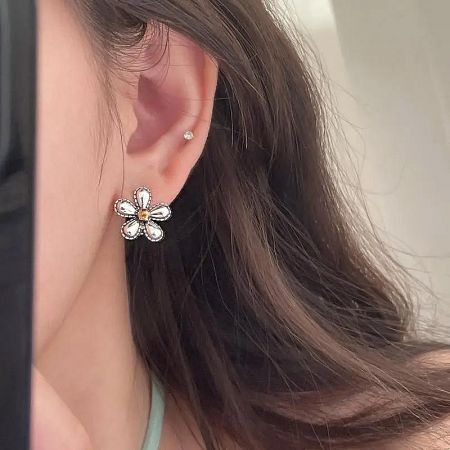 925 Sterling Silver Antique Oxidized Flower Latch-Back Earrings (5 Pairs) - A close-up of a woman wearing an elegant 925 sterling silver antique oxidized flower latch-back earring, showcasing its detailed floral design and secure fit.