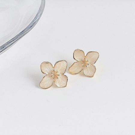 Detailed shot of the flower-shaped earrings showing the shiny material and gold accents.