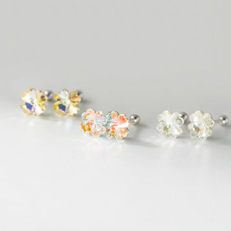 Detail shot of the yellow, white, and multi-colored crystal clover stud earrings.