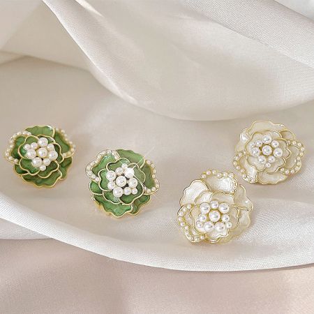 Wholesale 14k Gold Plated Enamel Camellia Flower Pearl Stud Earrings - Collection of 14k gold plated enamel camellia flower pearl stud earrings in white and green, available for wholesale from JR Fashion Accessories.