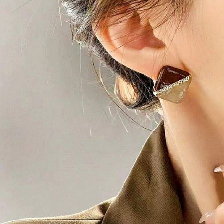 Close-up of the retro square stud earring being worn, showcasing its geometric design.