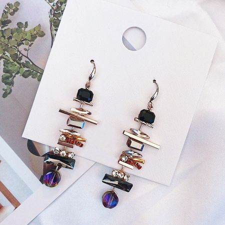 Close-up detail of the geometric stone arrangement on the vintage-inspired earrings.