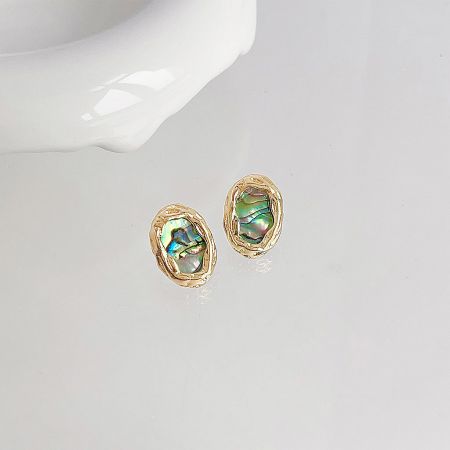 Close-up view of the iridescent abalone shell stud earrings, showcasing the beautiful play of colors.