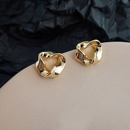 A clear product shot of the geometric Gold Triangle Post Earrings on a white surface.