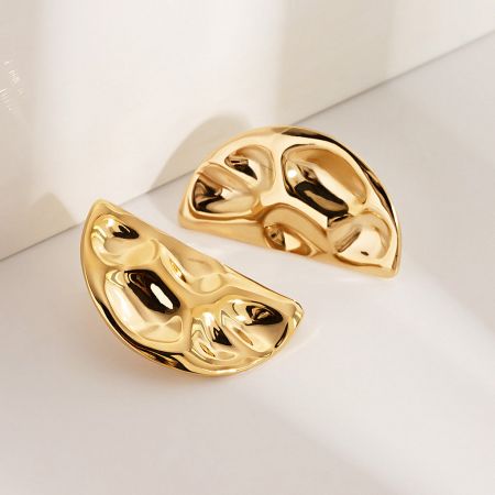 A pair of gold stainless steel half-circle stud earrings showcasing the unique abstract hammered design.