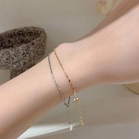 925 Sterling Silver Tiny Thin Square Geometry Chain Bracelet Set of 5 - A model's wrist adorned with the 925 sterling silver tiny thin square geometry chain bracelets, showcasing both the elegant silver and radiant gold finishes.