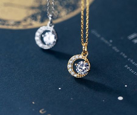 The Halo Round Pendant Necklace is available in both silver and gold plating options.