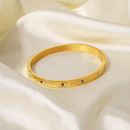 Detailed view of another evil eye bangle with vibrant colored gemstones.