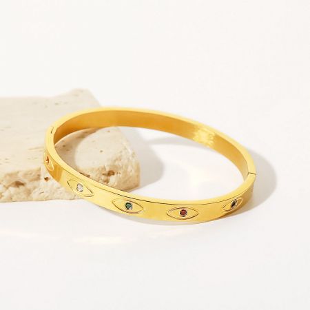 Elegant gold bangle adorned with an array of multicolored gemstones.