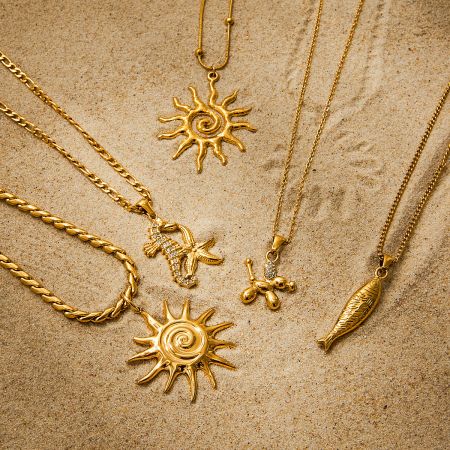 Close-up of the gold sun pendant necklace set, highlighting the waterproof and hypoallergenic stainless steel material.