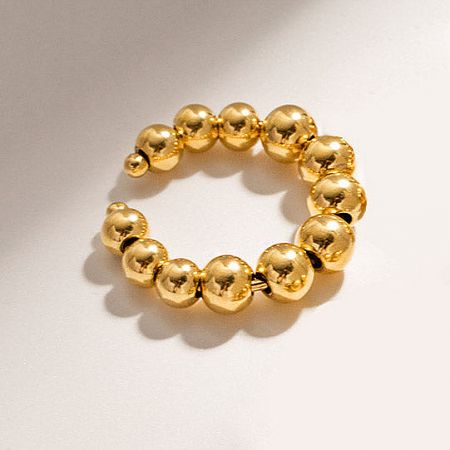 Gold beaded bracelet with a circular design.