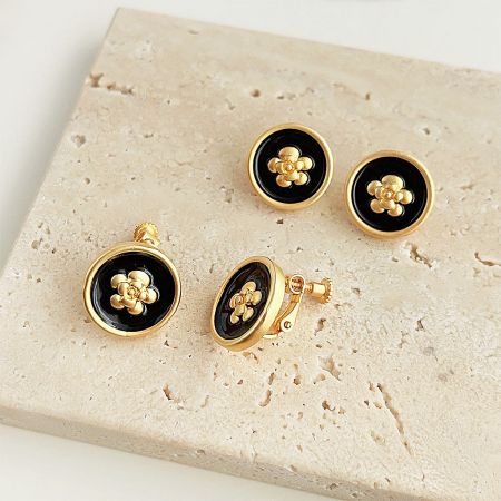 Complete jewelry set featuring gold and black floral earrings and cufflinks.