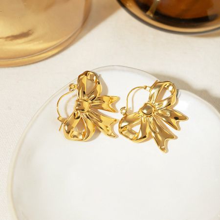 Stainless Steel Gold Plated Ribbon Bow Hinged Hook Earrings (5 pairs) - A pair of elegant gold-plated stainless steel earrings designed in a delicate ribbon bow shape, shown against a clean white background.
