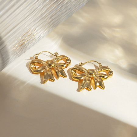 Side view of the gold-plated ribbon bow hinged hook earrings.
