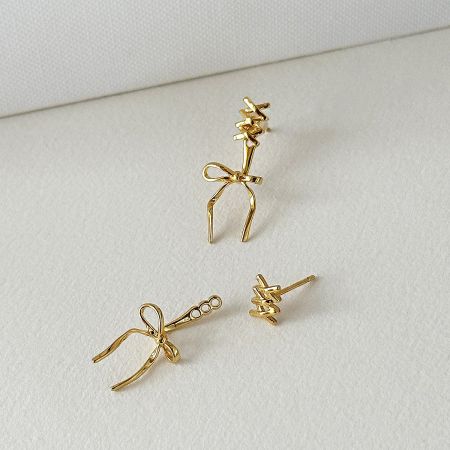 Close-up of the gold-plated 925 sterling silver bowknot stud earrings.