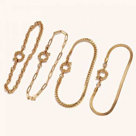 Women's Stainless Steel Waterproof & Non-Tarnish Chain Bracelets (Set of 5) - A collection of five women's stainless steel chain bracelets in a gold-plated finish, featuring various designs including paper clip and snake chains, arranged on a white background.