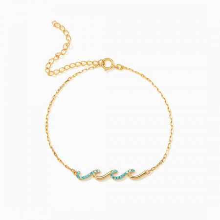 The gold version of the Glittering Waves bracelet shown on a wrist, highlighting its warm tone and delicate chain.