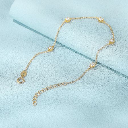 A detailed shot of the gold-plated sterling silver bracelet, showing the adjustable clasp.