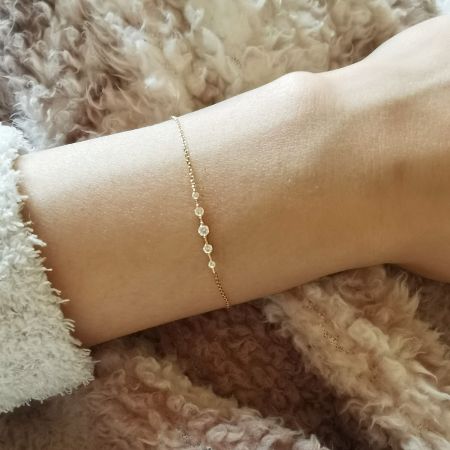 A close-up view of the sterling silver zircon bracelet on a model's wrist.