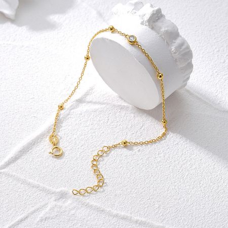 Another view of the gold bracelet highlighting its delicate chain and clasp mechanism.