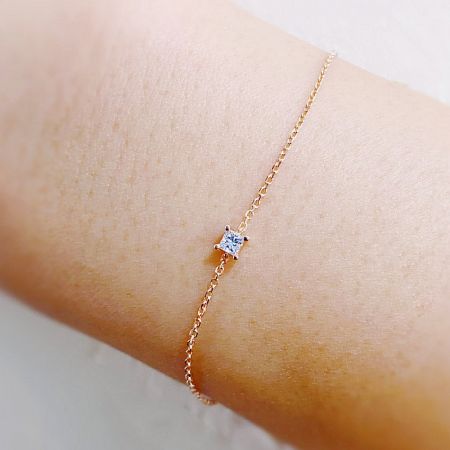 A model wearing the delicate 925 sterling silver solitaire bracelet, showcasing its fit on the wrist.