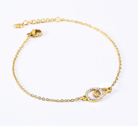 Gold-plated bracelet featuring an interlocking circle design adorned with sparkling white stones.