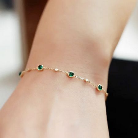 Lifestyle image of the emerald and zircon bracelet being worn.