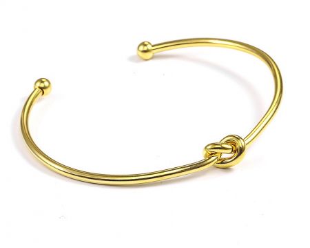 Gold Knot Bangle in Stainless Steel - Close-up of the Gold Knot Bangle in stainless steel, featuring an elegant knot design and polished spherical ends.