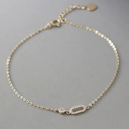 Close-up of a geometric cubic zirconia bracelet from the set, worn on a wrist to show detail.
