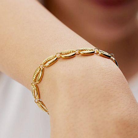 Gold bracelet with oval links on a white background.