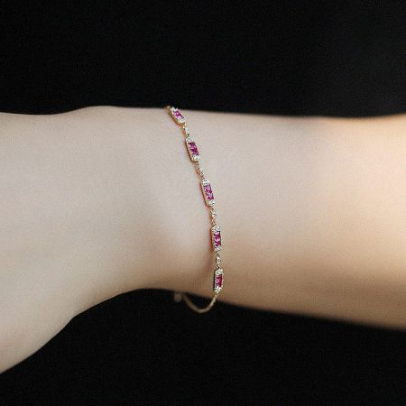 Close-up of the 925 sterling silver ruby charm bracelet, highlighting the pink gemstone and polished finish.