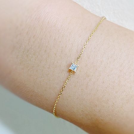 Close-up of a single 925 sterling silver bracelet with a square cubic zirconia stone.