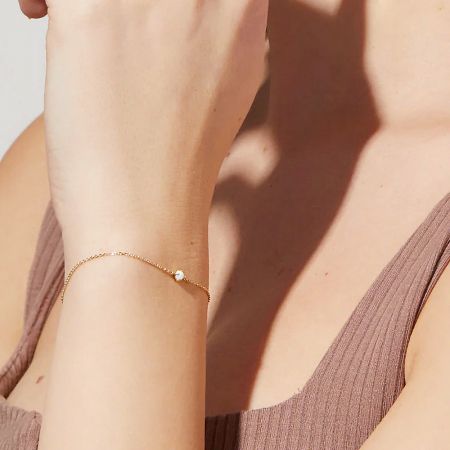 Detailed view of the gold 925 sterling silver bracelet with an opal charm.