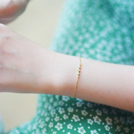 Detailed shot of the five zircon stones on the gold-plated bracelet.