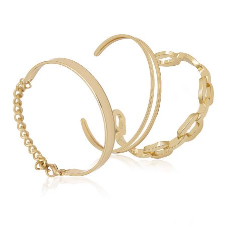 Detailed product shot of two gold stacking bangles, highlighting the craftsmanship and material.