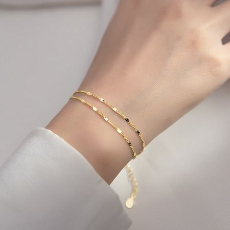 925 Sterling Silver Gold Link Chain Bracelet - A close-up view of the 925 Sterling Silver Gold Link Chain Bracelet elegantly worn on a wrist, showcasing its intricate link design and radiant gold finish.