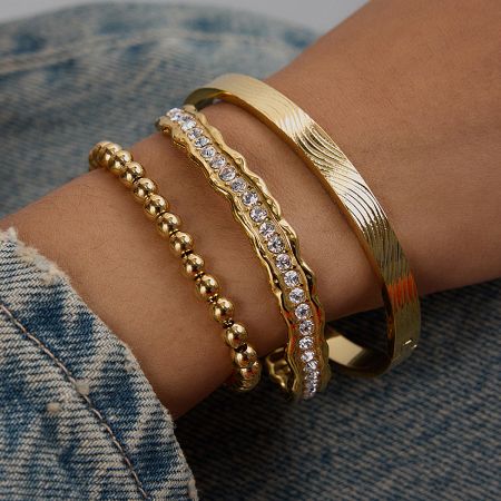 Adjustable Gold Plated Zircon Cuff Bracelets Waterproof Stainless Steel Jewelry Set of 5 - A close-up of a wrist adorned with a set of three adjustable gold-plated zircon cuff bracelets, highlighting their elegant design and high-quality stainless steel texture.