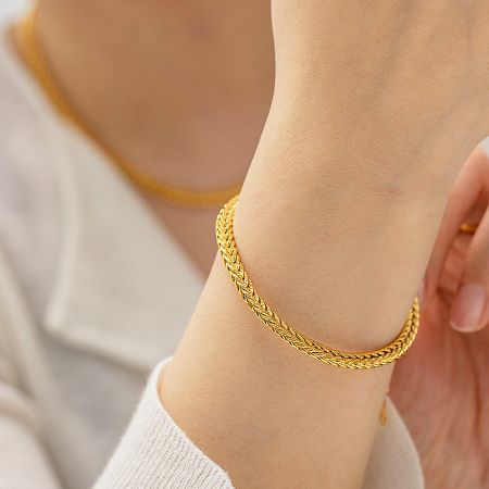 Stainless Steel Retro Wide Curb Chain Bracelets - Set of 5 - A close-up view of a person wearing the gold-plated stainless steel retro wide curb chain bracelet, showcasing its detailed design.