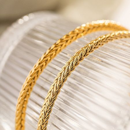 Another perspective of the gold braided chain, highlighting its intricate design.