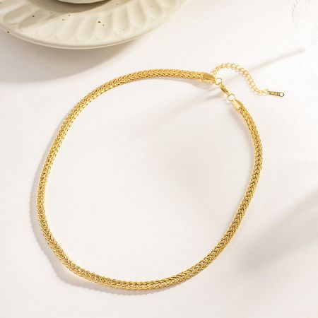 Detailed view of the clasp on the gold twisted rope chain necklace.