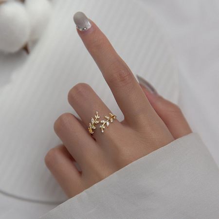 Detailed view of the gold-plated sterling silver leaf ring with a delicate branch design.